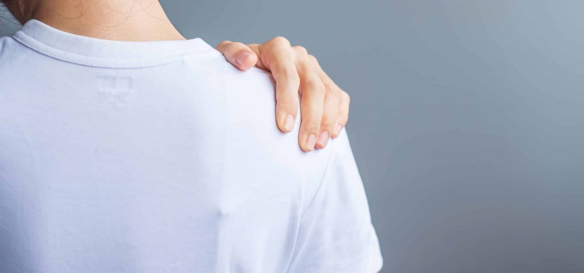 woman with her shoulder sprain, muscle painful during overwork. Girl having body problem after wake up. Shoulder ache, Scapular pain, office syndrome and ergonomic concept